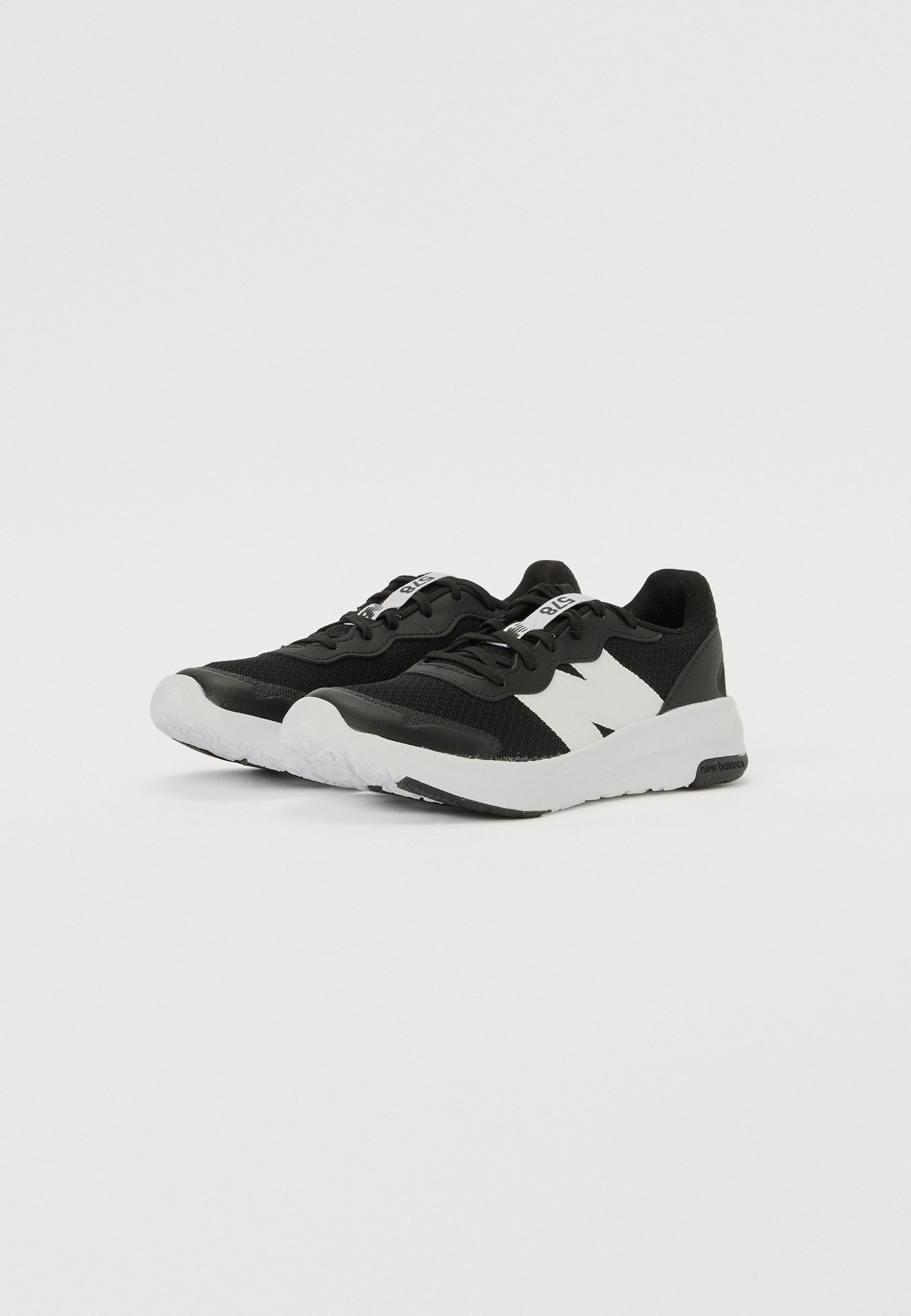 Zapatillas deportivas negras con una parte superior texturizada, acentos blancos y una suela de goma blanca. Incluyen cordones y un logotipo prominente en el lateral.