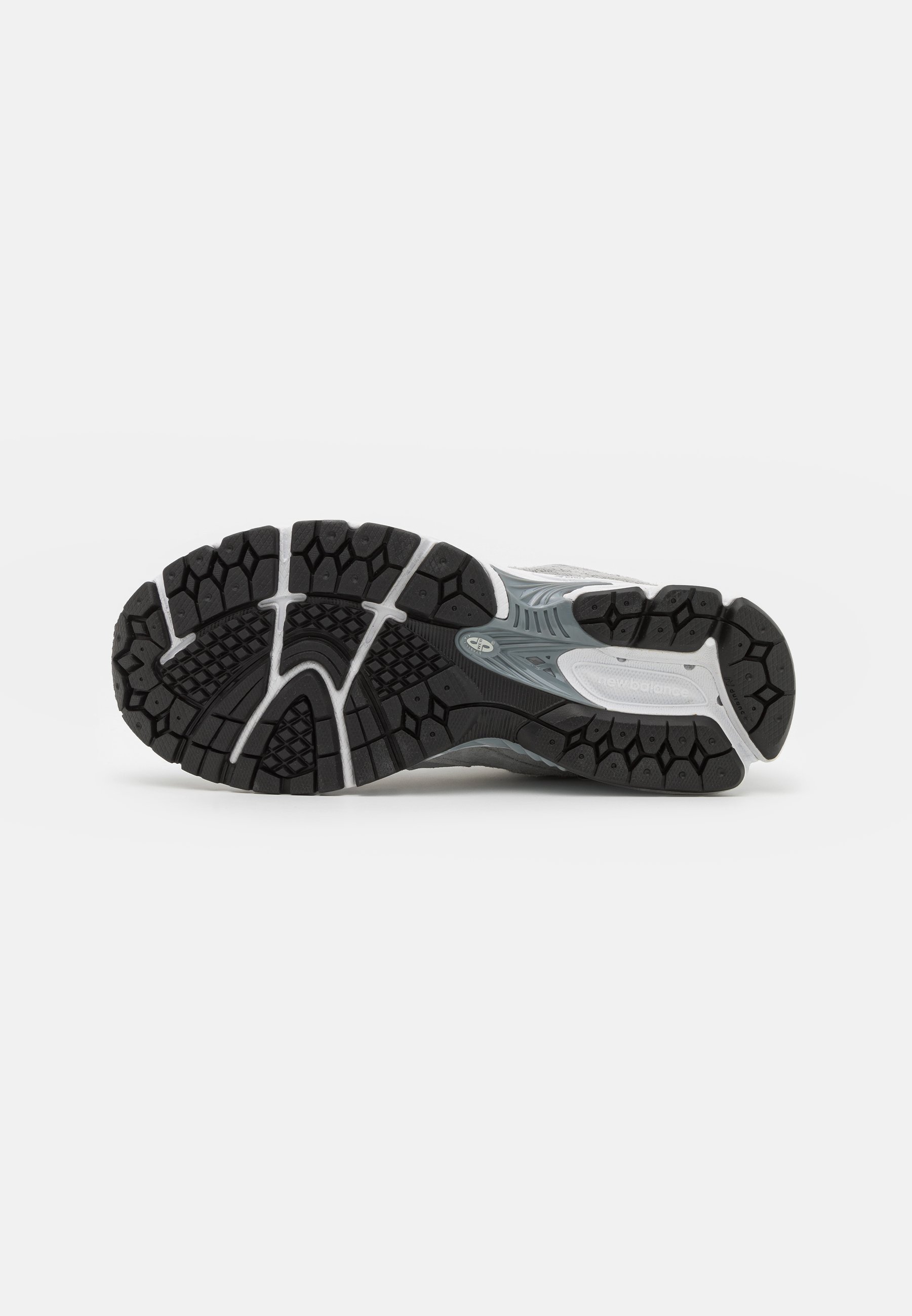 Suela de zapatilla deportiva con un diseño de goma negra, patrones hexagonales texturizados, acentos en blanco y una forma curva y ergonómica.