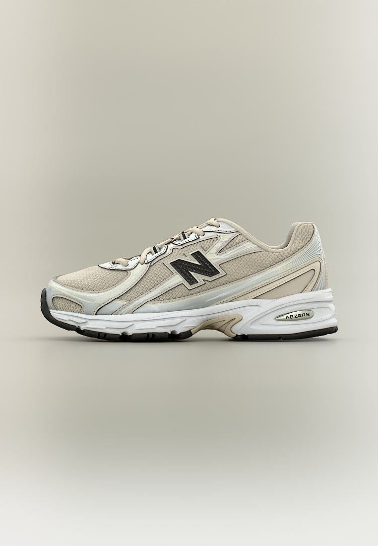 Zapatilla de running New Balance beige y blanca con logo negro, suela acolchada etiquetada como ABZORB y cordones beige sobre un fondo neutro.