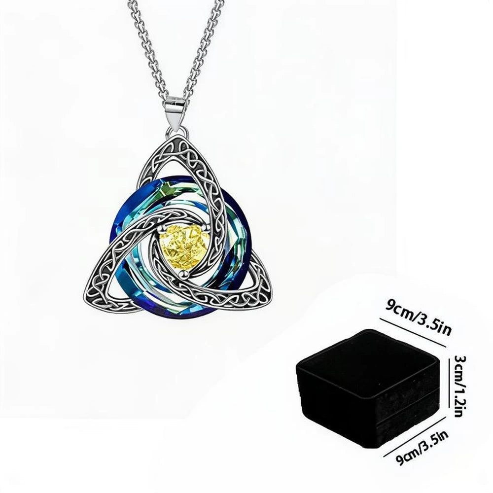 Silver Celtic knot triquetra pendant necklace with a blue and green marbled center and a yellow gemstone, shown on a white background with a black jewelry box and size annotations.