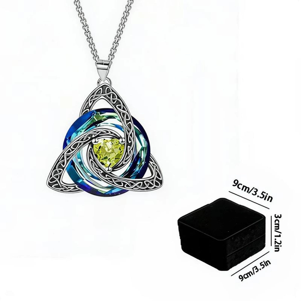 Silver Celtic knot triquetra pendant necklace with blue and green iridescent swirls and a yellow center stone, shown on a white background with a small black box and dimension labels.