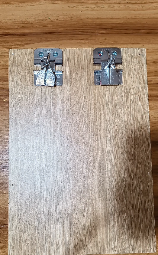 Hinge clamps on a board for simple screen printing registration.