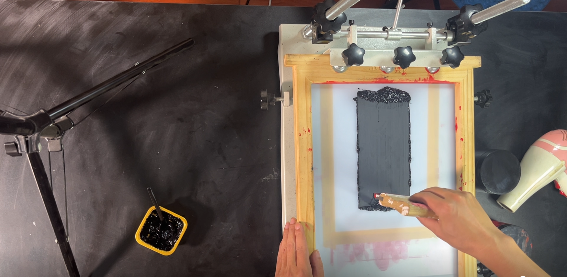 Pulling the squeegee in one steady pass with consistent angle and pressure