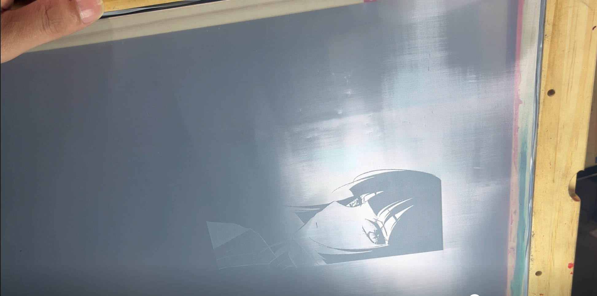 Finished stencil on the screen after exposure, showing artwork details ready to print