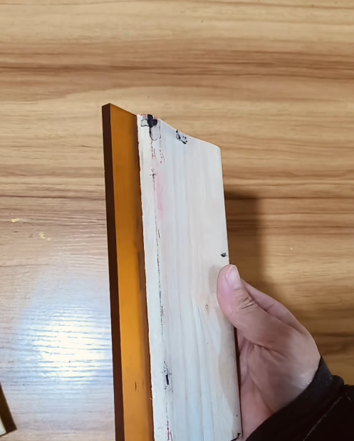 Wooden screen printing squeegee with an orange rubber blade (beginner setup).