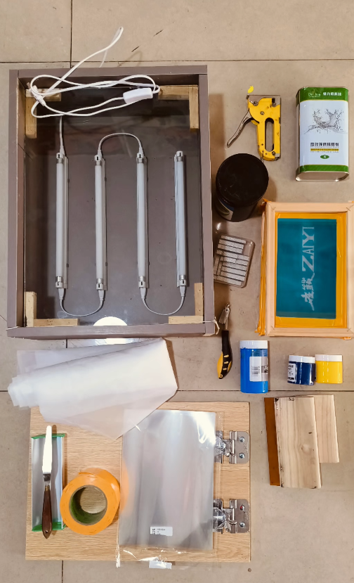 Beginner screen printing starter kit layout: exposure unit, screen frame, squeegee, inks, tape and tools