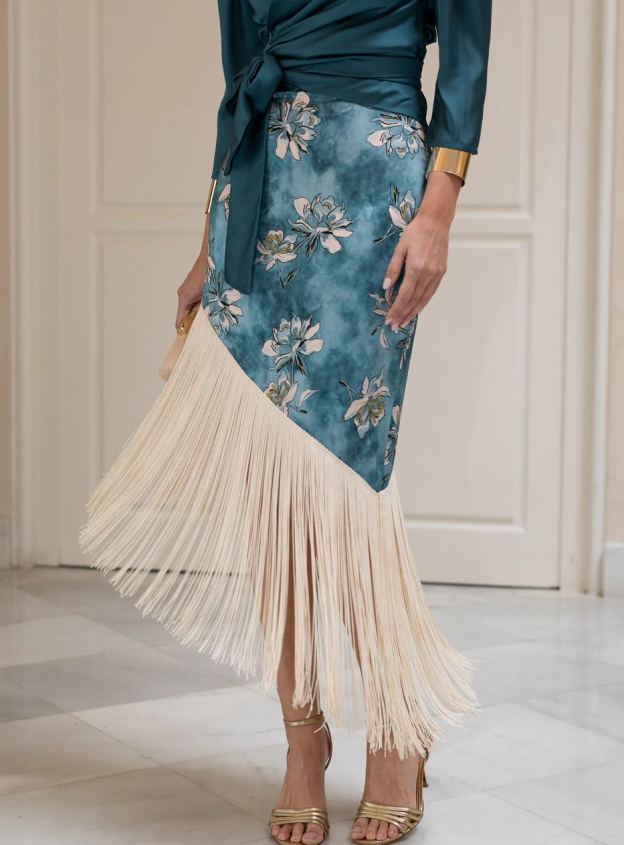 Blouse and fringed skirt set in petrol blue.