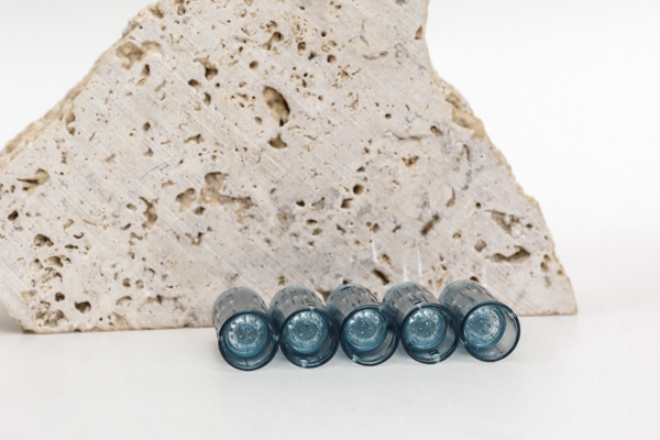 5 dr pen microneedling cartridge in front of rock decoration