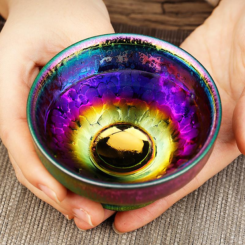 Peacock Plume Jian Zhan Tea Cup with colorful iridescent glaze and golden floral decoration, handcrafted ceramic from TeaSouls Jian Zhan Studio.