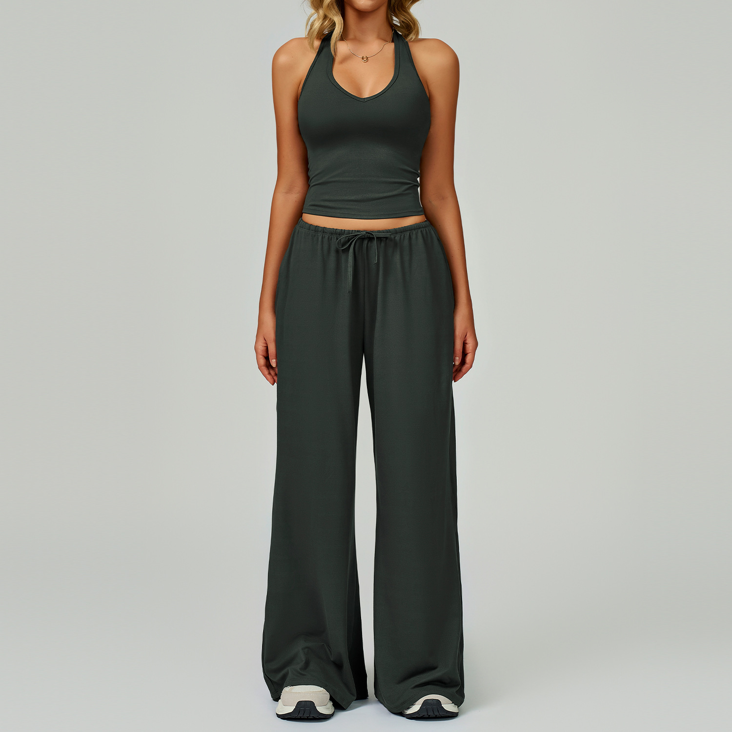 Women's Casual Sportswear Set — A slim-fitting, summer-style athletic outfit crafted from silky-feel polyester. It features an adjustable V-neck camisole paired with wide-leg trousers. Cool, quick-drying, and breathable, this set accentuates your alluring