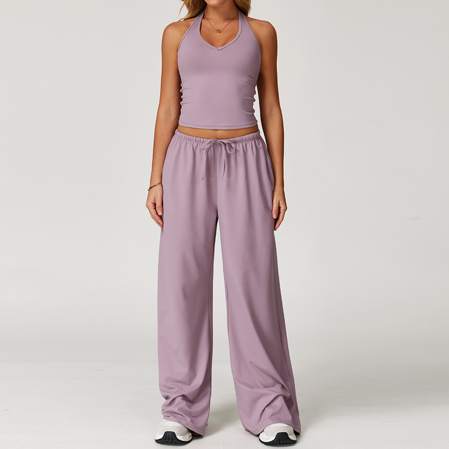 Women's Casual Sportswear Set — A slim-fitting, summer-style athletic outfit crafted from silky-feel polyester. It features an adjustable V-neck camisole paired with wide-leg trousers. Cool, quick-drying, and breathable, this set accentuates your alluring