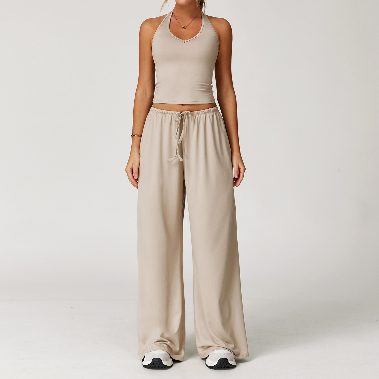 Women's Casual Sportswear Set — A slim-fitting, summer-style athletic outfit crafted from silky-feel polyester. It features an adjustable V-neck camisole paired with wide-leg trousers. Cool, quick-drying, and breathable, this set accentuates your alluring