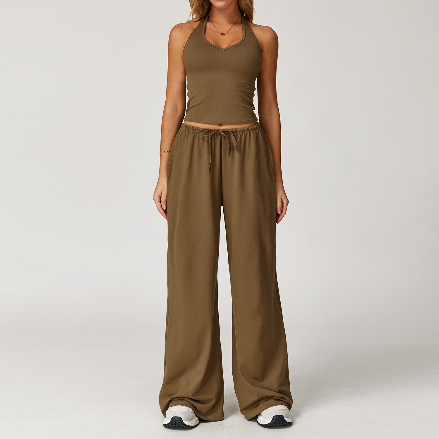 Women's Casual Sportswear Set — A slim-fitting, summer-style athletic outfit crafted from silky-feel polyester. It features an adjustable V-neck camisole paired with wide-leg trousers. Cool, quick-drying, and breathable, this set accentuates your alluring