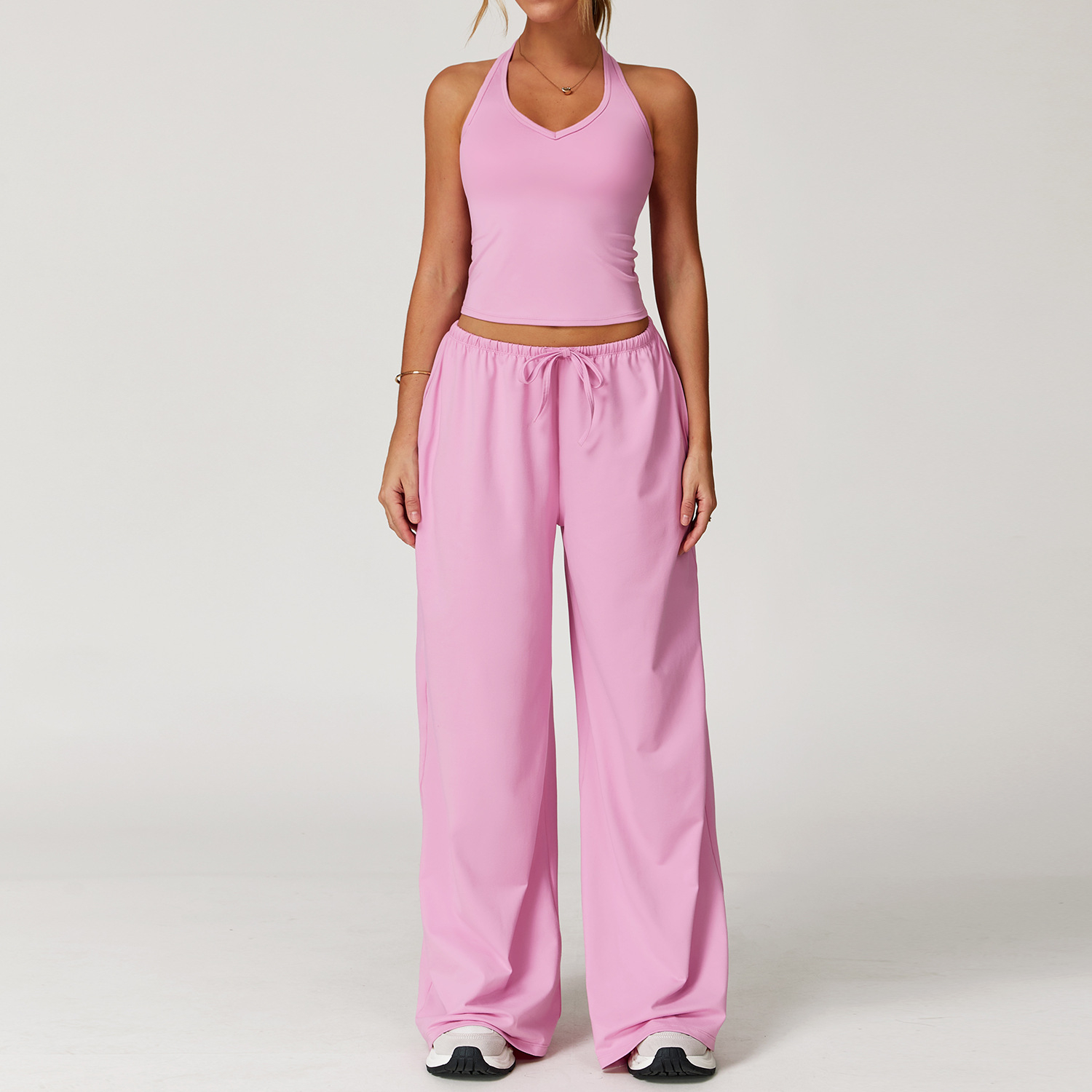 Women's Casual Sportswear Set — A slim-fitting, summer-style athletic outfit crafted from silky-feel polyester. It features an adjustable V-neck camisole paired with wide-leg trousers. Cool, quick-drying, and breathable, this set accentuates your alluring