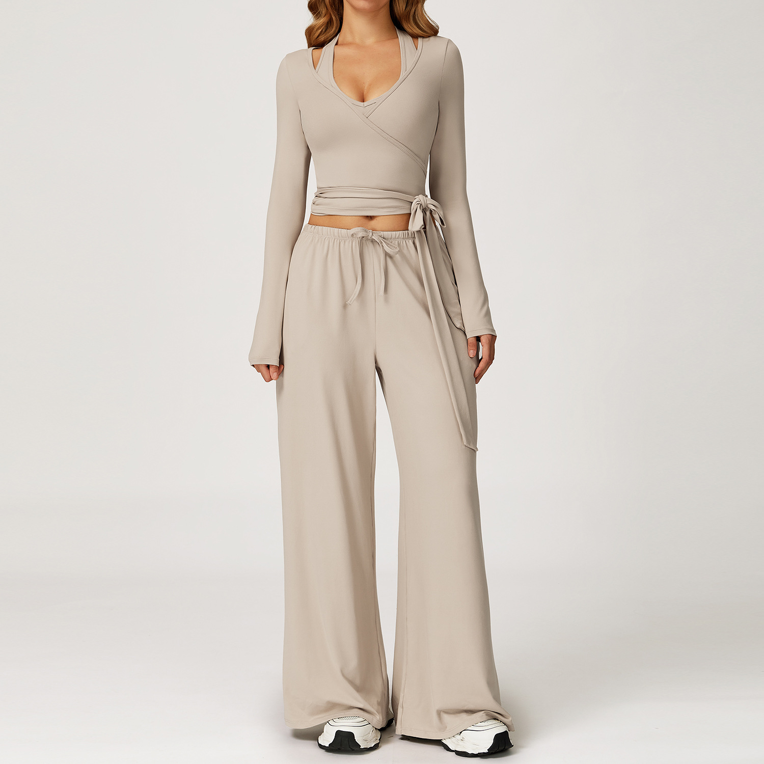 Women's Casual Sportswear Set — A slim-fitting, summer-style athletic outfit crafted from silky-feel polyester. It features an adjustable V-neck camisole paired with wide-leg trousers. Cool, quick-drying, and breathable, this set accentuates your alluring