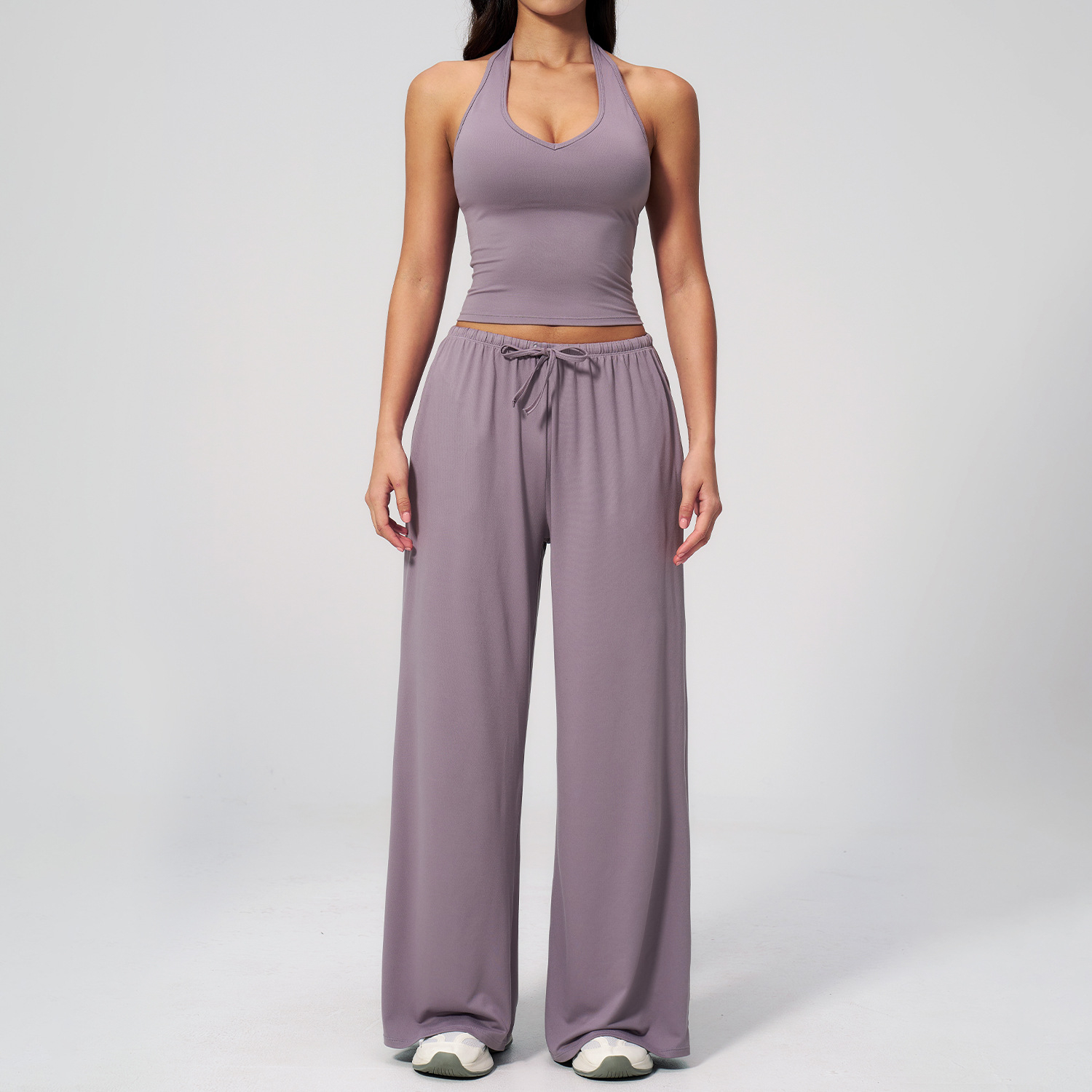 Women's Casual Sportswear Set — A slim-fitting, summer-style athletic outfit crafted from silky-feel polyester. It features an adjustable V-neck camisole paired with wide-leg trousers. Cool, quick-drying, and breathable, this set accentuates your alluring