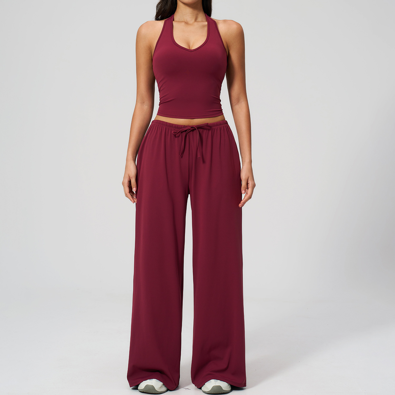 Women's Casual Sportswear Set — A slim-fitting, summer-style athletic outfit crafted from silky-feel polyester. It features an adjustable V-neck camisole paired with wide-leg trousers. Cool, quick-drying, and breathable, this set accentuates your alluring