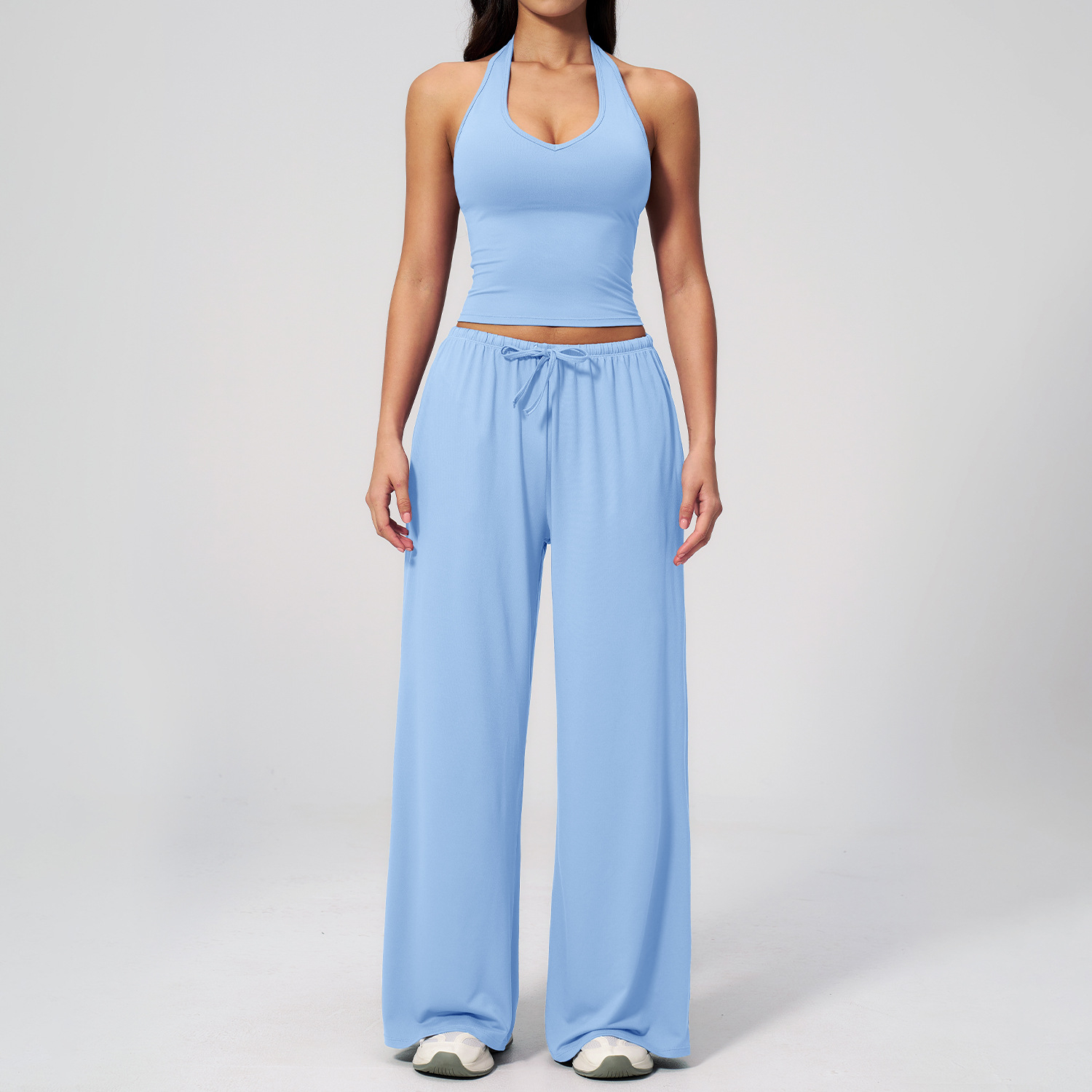 Women's Casual Sportswear Set — A slim-fitting, summer-style athletic outfit crafted from silky-feel polyester. It features an adjustable V-neck camisole paired with wide-leg trousers. Cool, quick-drying, and breathable, this set accentuates your alluring