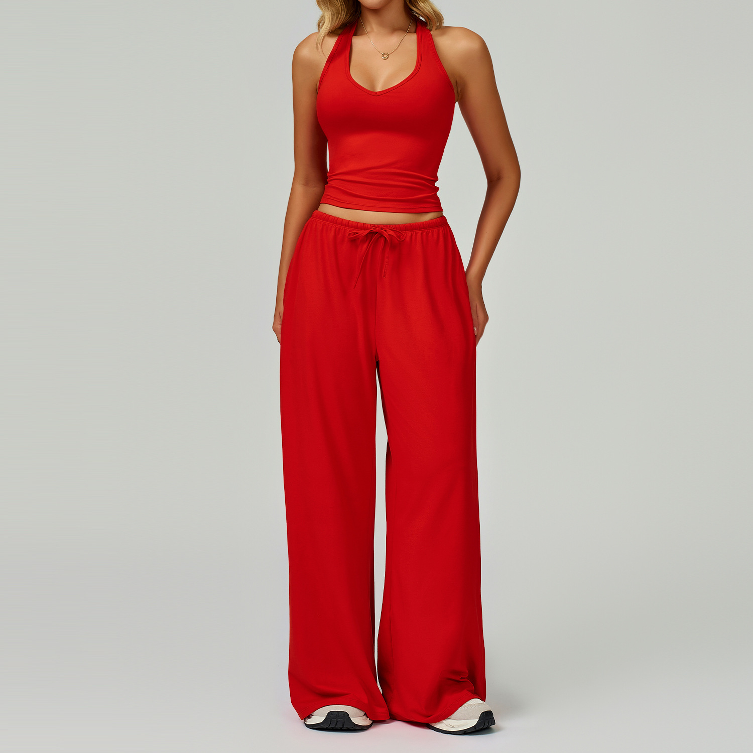 Women's Casual Sportswear Set — A slim-fitting, summer-style athletic outfit crafted from silky-feel polyester. It features an adjustable V-neck camisole paired with wide-leg trousers. Cool, quick-drying, and breathable, this set accentuates your alluring