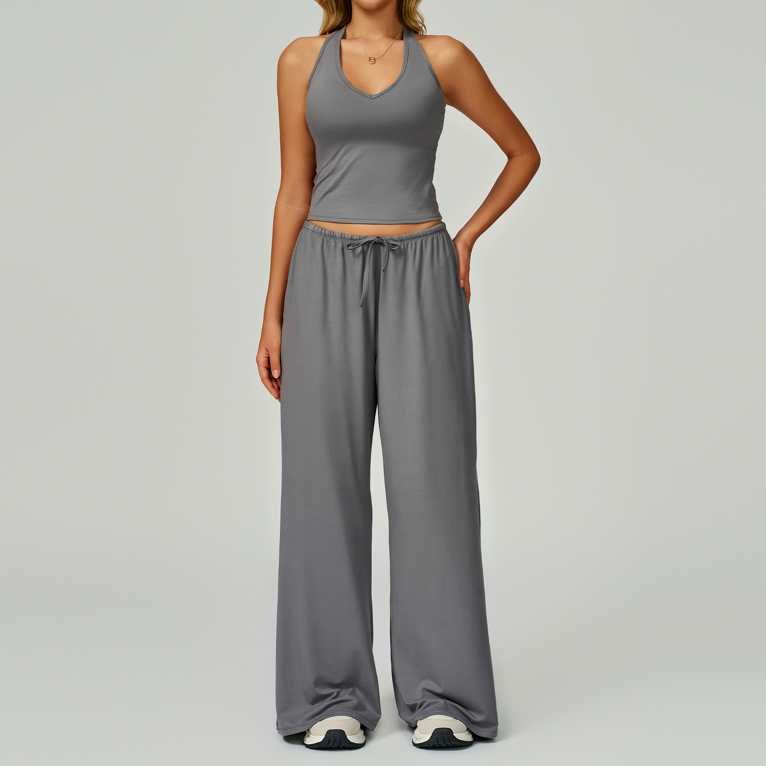 Women's Casual Sportswear Set — A slim-fitting, summer-style athletic outfit crafted from silky-feel polyester. It features an adjustable V-neck camisole paired with wide-leg trousers. Cool, quick-drying, and breathable, this set accentuates your alluring
