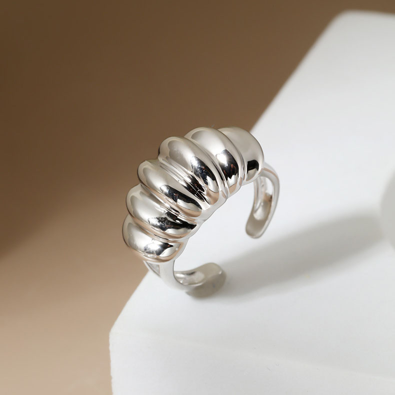 Overhead flat lay of S925 Sterling Silver Adjustable Croissant Ring on marble surface
