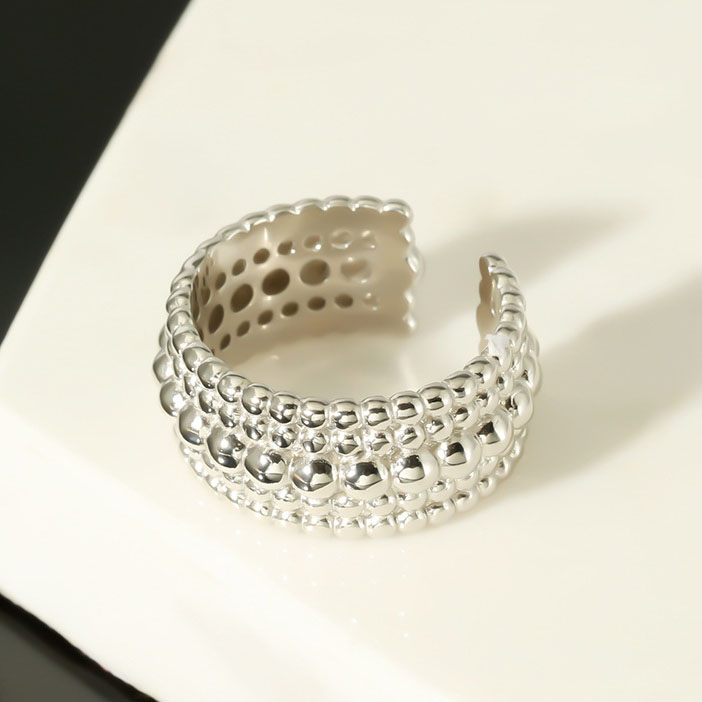 Front view of Polka Dot Circle Ring in Solid 925 Sterling Silver on marble background