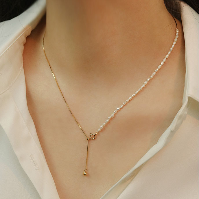 Women modeling dual-layer snake and pearl choker necklace front view, bohemian layered style