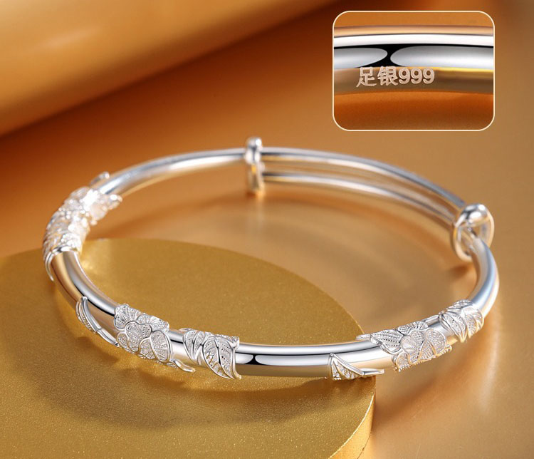 Close-up macro shot of the .999 sterling silver hallmark on the adjustable bangle