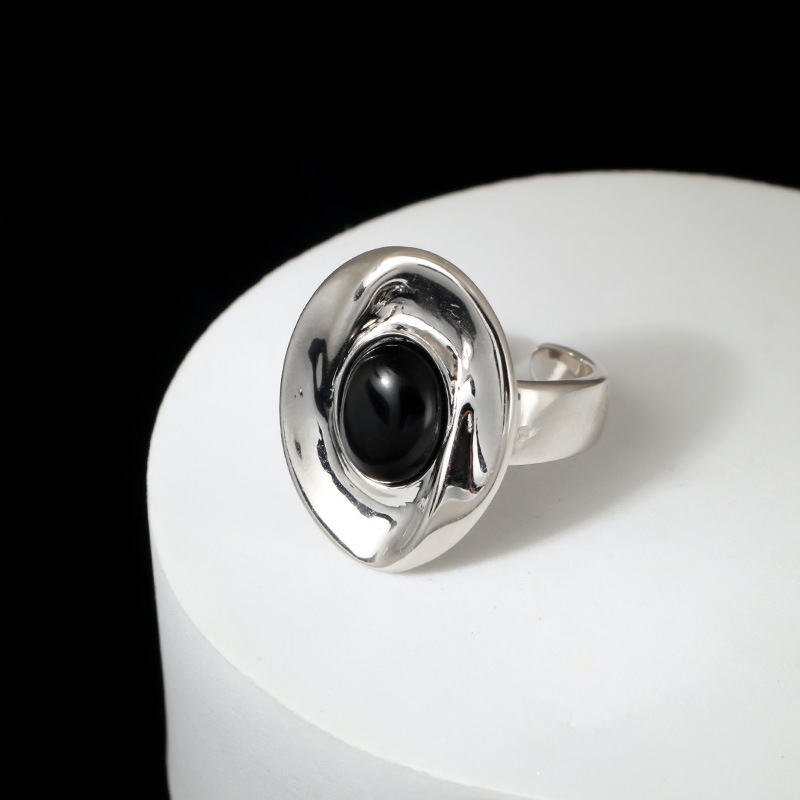 Overhead flat lay of Textured Black Onyx Statement Ring on marble surface
