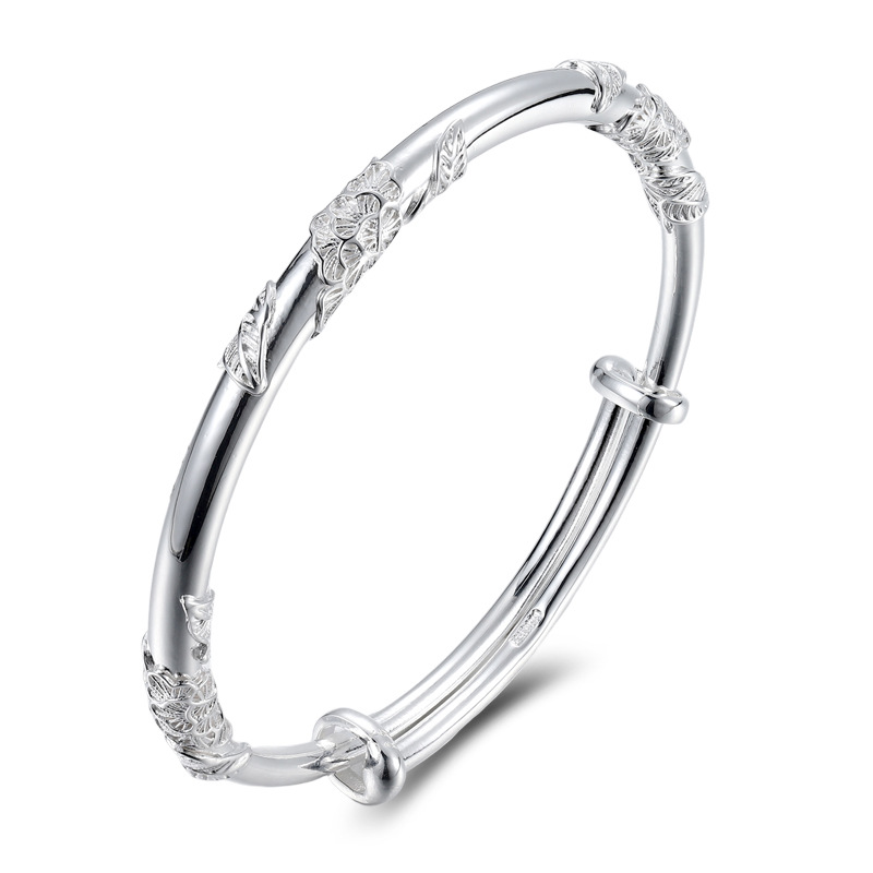 Solid .999 Sterling Silver Adjustable Floral Bangle Bracelet isolated on a white background