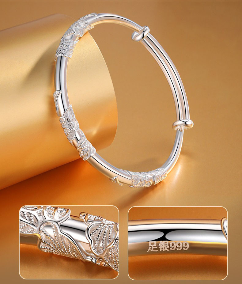 Detailed view of the filigree floral design next to the stamped .999 fine silver quality mark