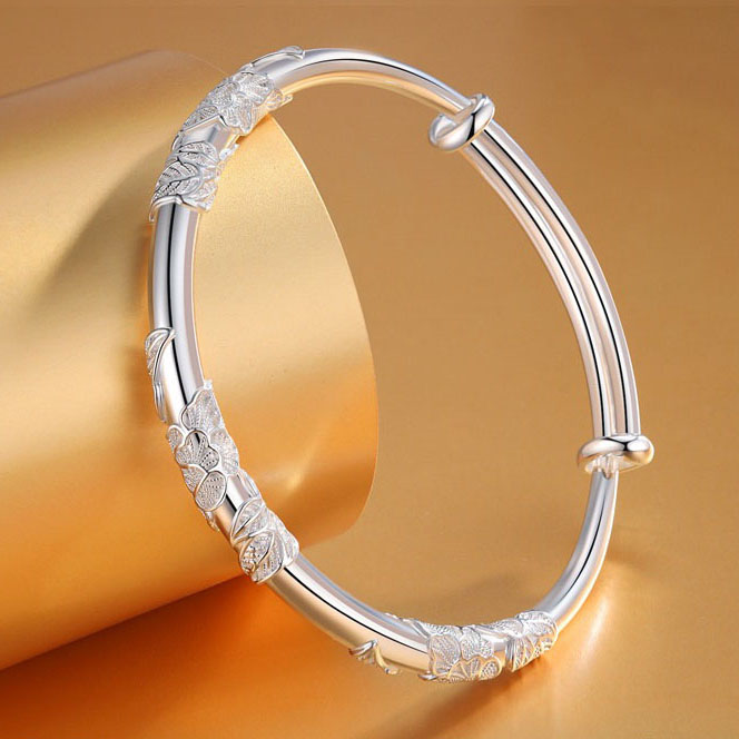 Handmade Filigree Floral Bangle Bracelet displayed on a vibrant yellow background