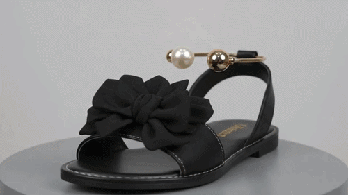 Hero GIF placeholder: woman walking in Fleetheritage bowknot pearl flat sandals on a sunny summer street