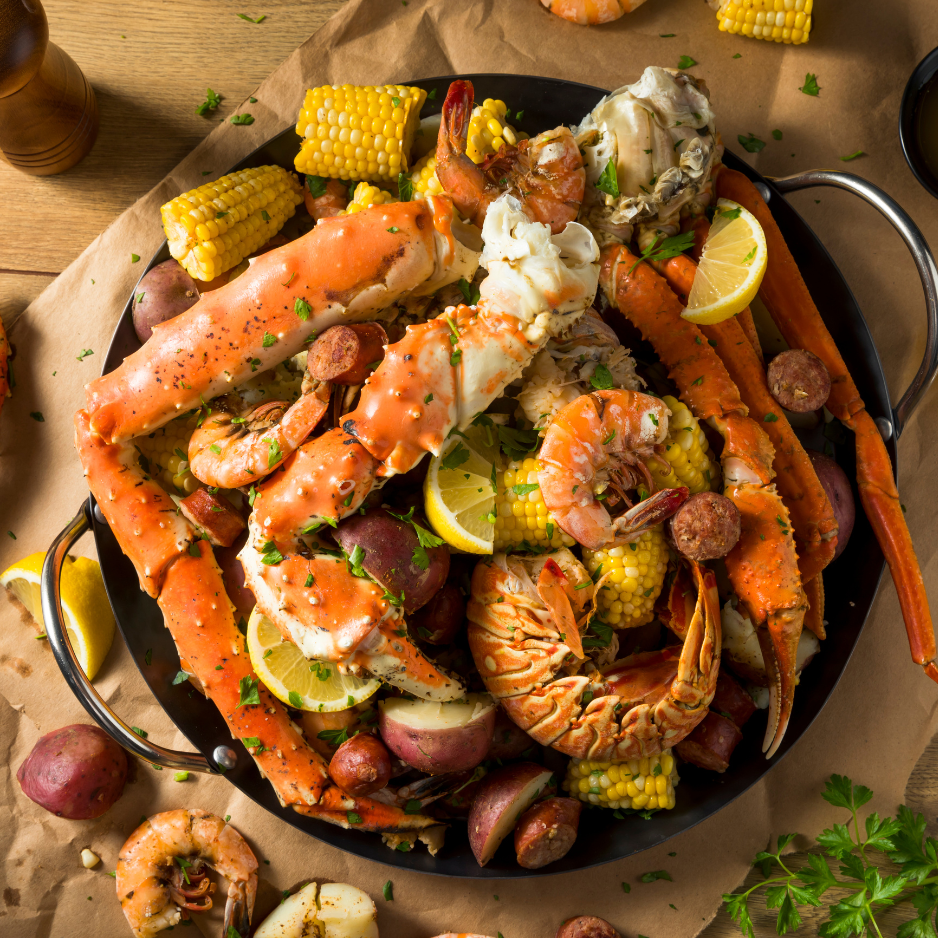 seafood boil platter with crab shrimp corn potatoes and sausage