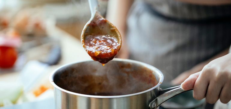 mother sauce being cooked and displayed on a serving spoon