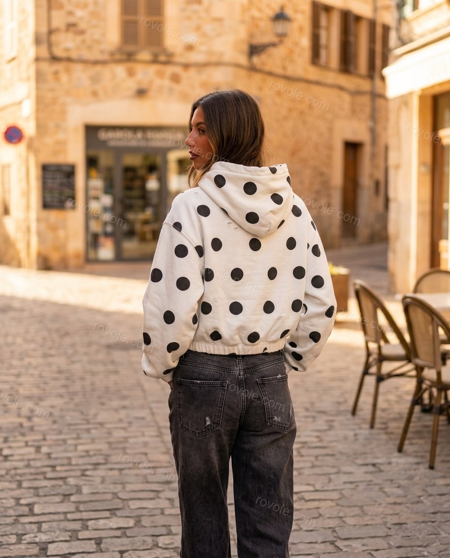 White Polka Dot Knit Top, walking lifestyle view, by rovole.com