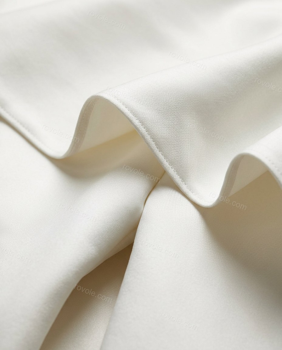 White Midi Off-Shoulder High-Low Dress, close-up of asymmetrical neckline, one off-the-shoulder draped bell sleeve and fitted bodice, by rovole.com