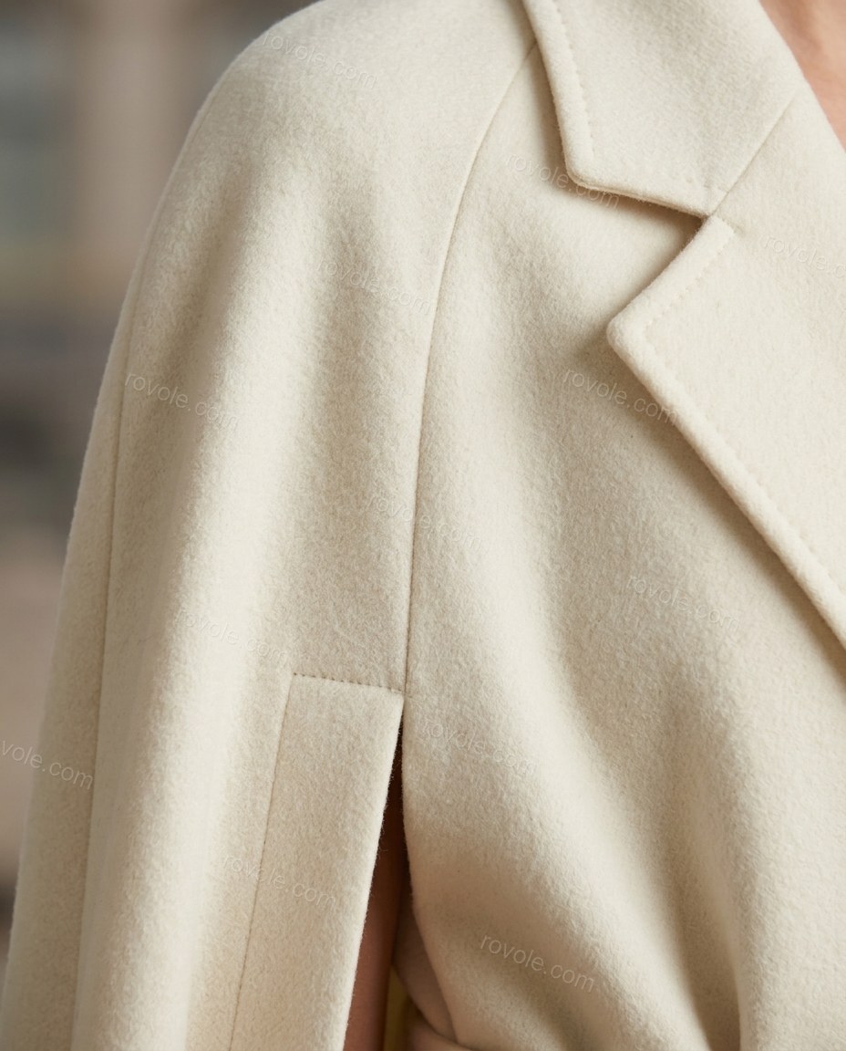 Cream Cape Coat, close-up of front button closure, lapel collar and wide notched lapels, by rovole.com