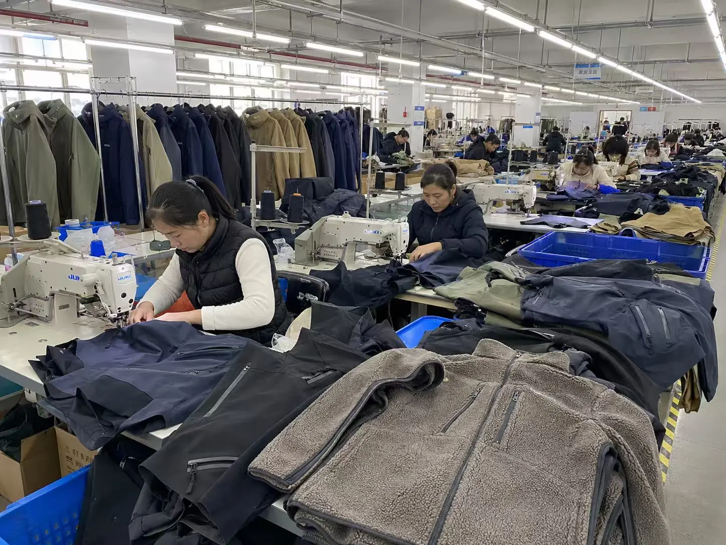 Focused operators working with outerwear components