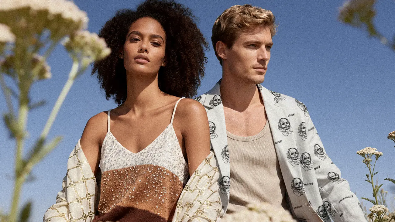 {"default":"Fashion clothing banner featuring a model in a sequined top and patterned kimono cover-up"}
