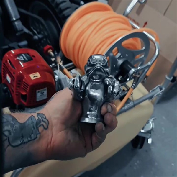 Car enthusiast holding the angry duck ornament in a workshop