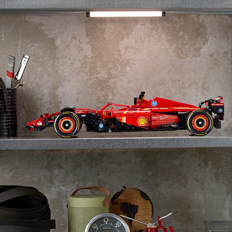 LEGO model of a red race car displayed on a shelf in a home