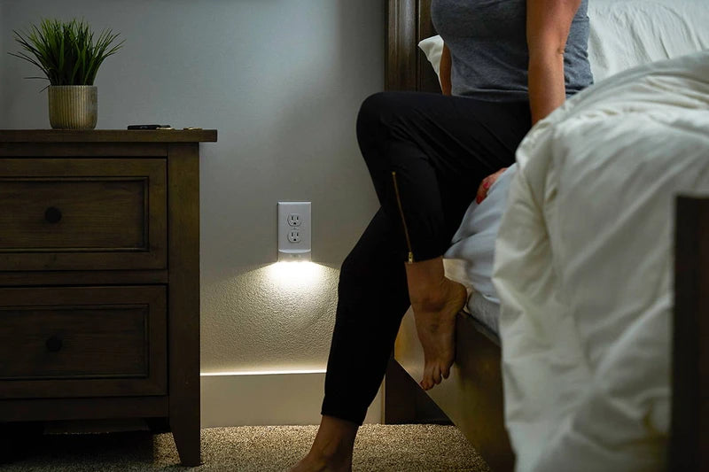 Bedroom view showing the subtle glow from the lighted wall outlet