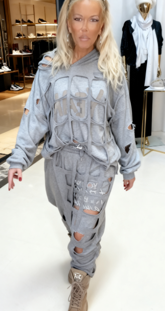 Dwuczęściowy komplet zawiera ubrania z nadrukowanymi literami i wycinanymi wzorami.