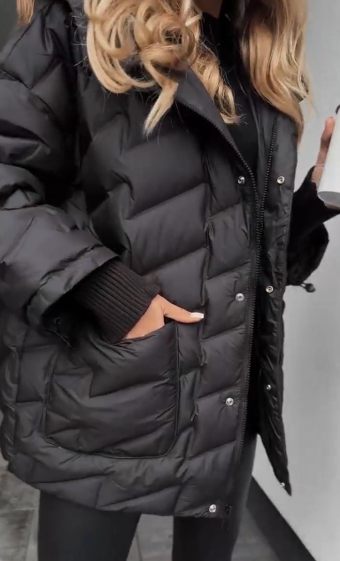 Kurtka puchowa z kapturem i fakturowaną fakturą, sięgająca do połowy łydki.