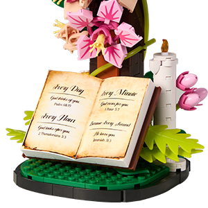 Green leaves and botanical branches arranged around the Christian cross building model