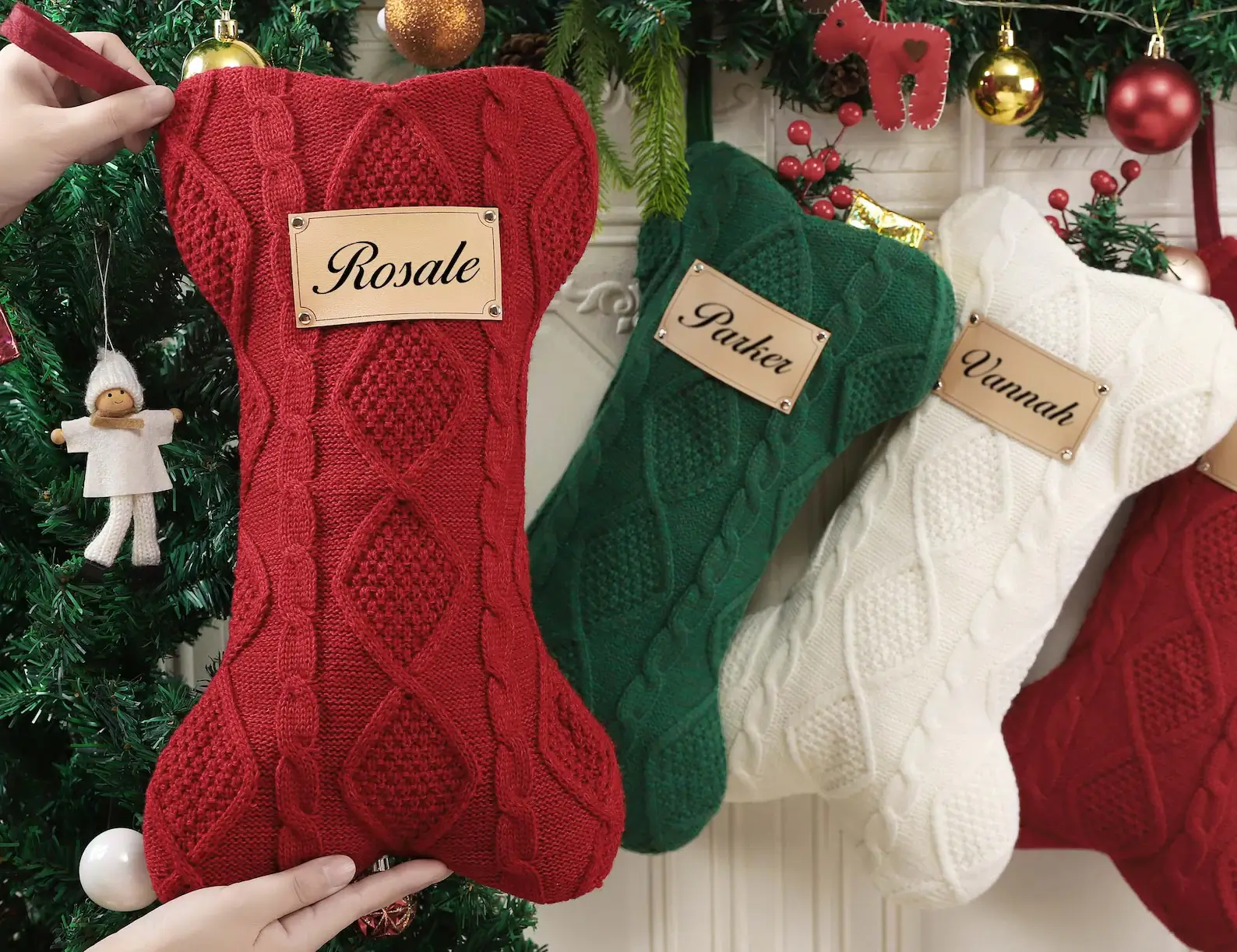 Adorable dog with a custom bone-shaped pet Christmas stocking, personalized with a name. Ideal for furry family members.