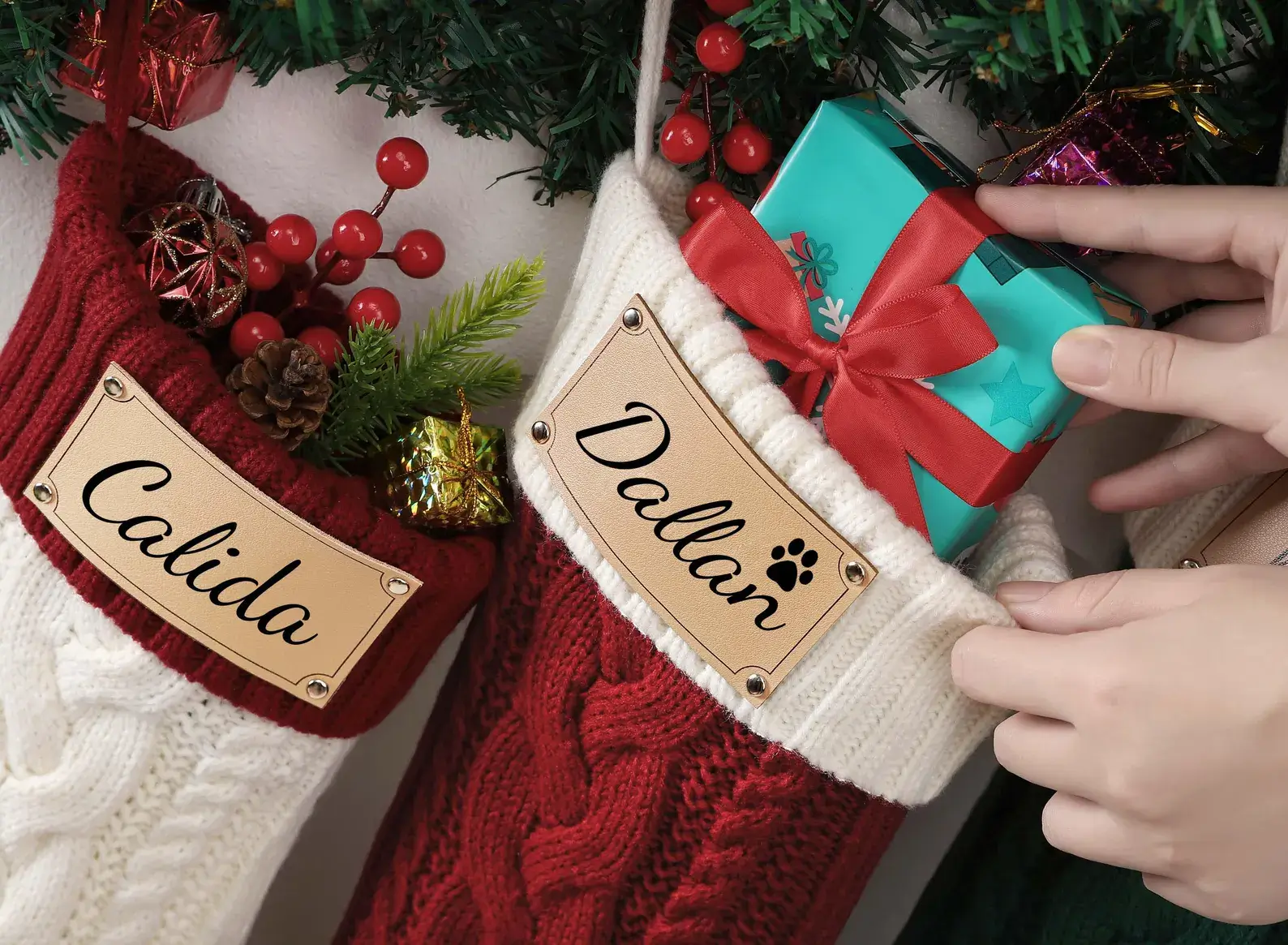 Close-up of a personalized Christmas stocking showing the precision engraved name on the premium leather cuff. Highlights the quality of customized holiday decor.