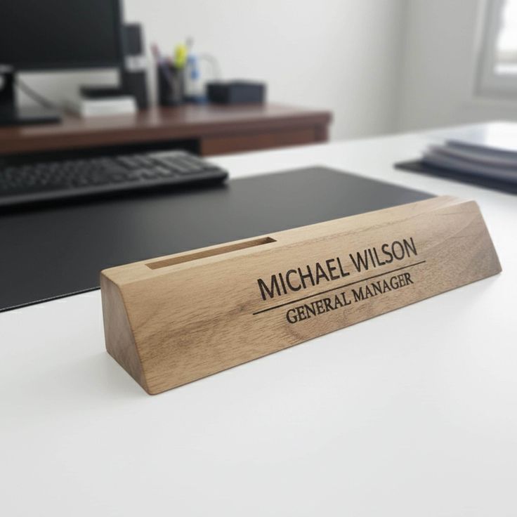 A handcrafted wooden desk name plate with engraved text, showcasing natural wood grain for a warm and rustic office look.