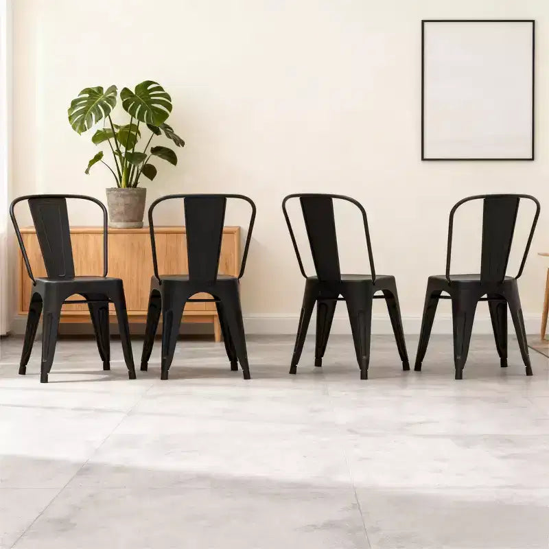 Dyonery 4 black metal chairs, with multi-hole seat designs and backrest arcs that conform to the curves of the human back